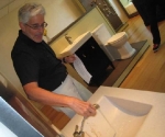 Gary demonstrates the pullout Outreach bathroom faucet.