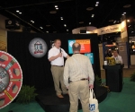 Erik Hoffer taps his inner Alex Trebeck to run the quiz game at the Home Fire Sprinkler Coalition booth.